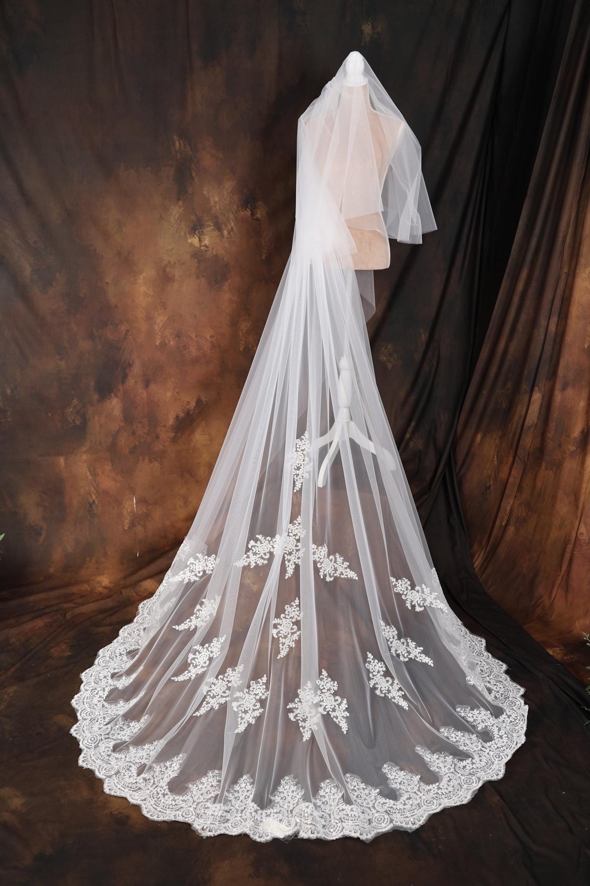 a wedding veil with white flowers on it