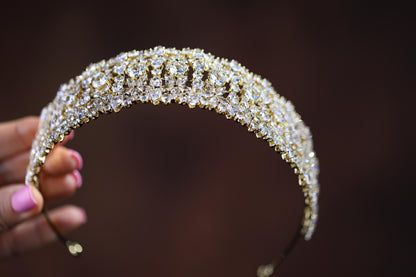 a close up of a person holding a tiara