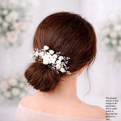 the back view of a woman's head with a bun hairstyle adorned with white flowers.