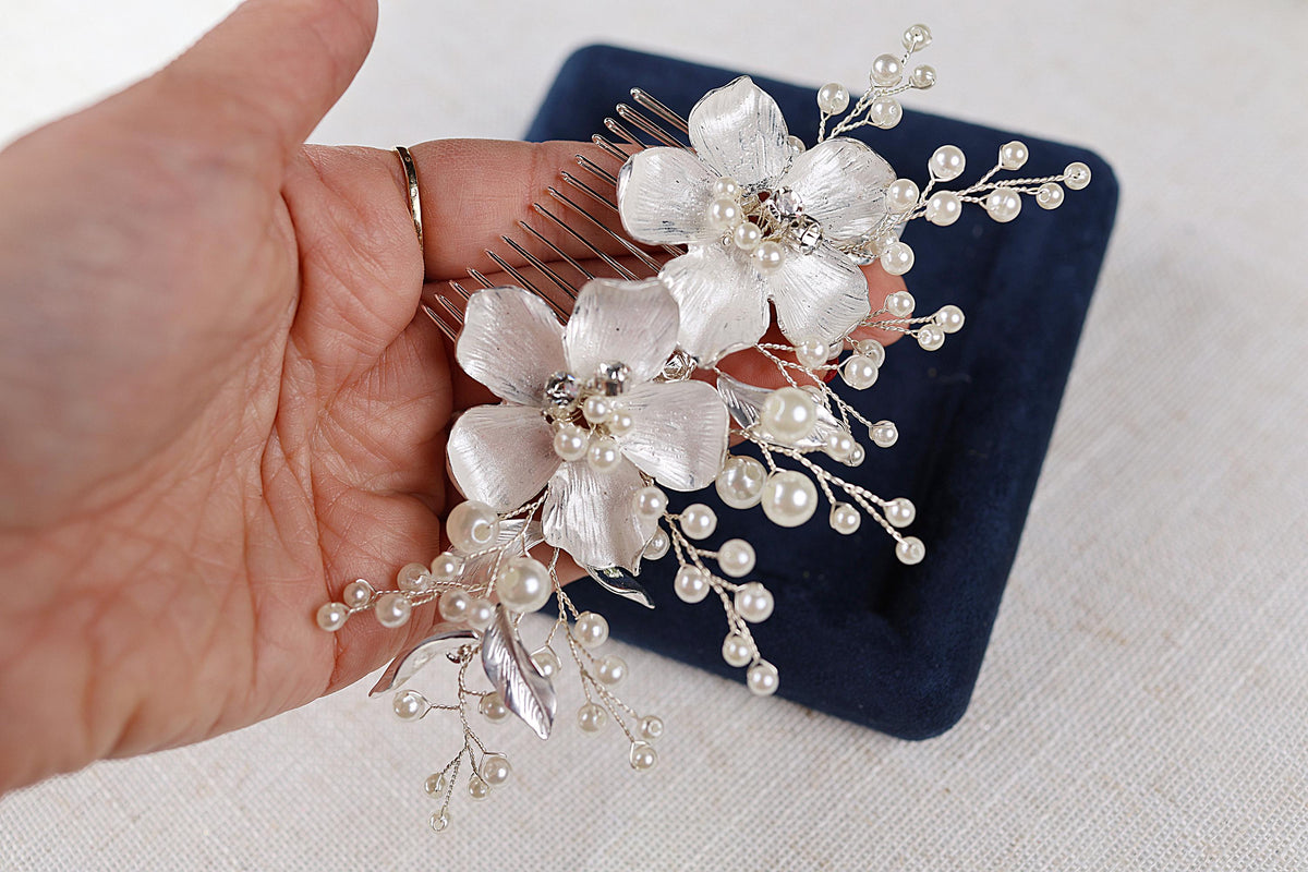 a person holding a hair comb with flowers on it