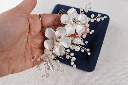 a person holding a hair comb with flowers on it