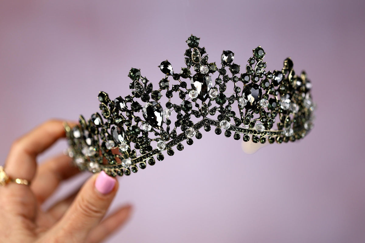 a woman holding a tiara in her hand