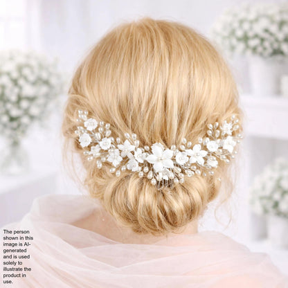 a woman's blonde hair styled in a bun, adorned with a decorative hair accessory featuring white flowers.