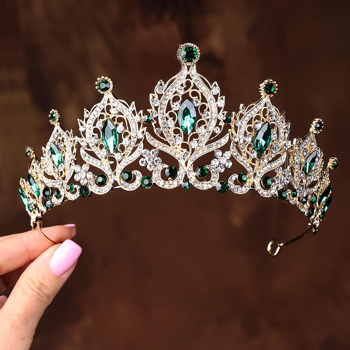 a close up of a person holding a tiara