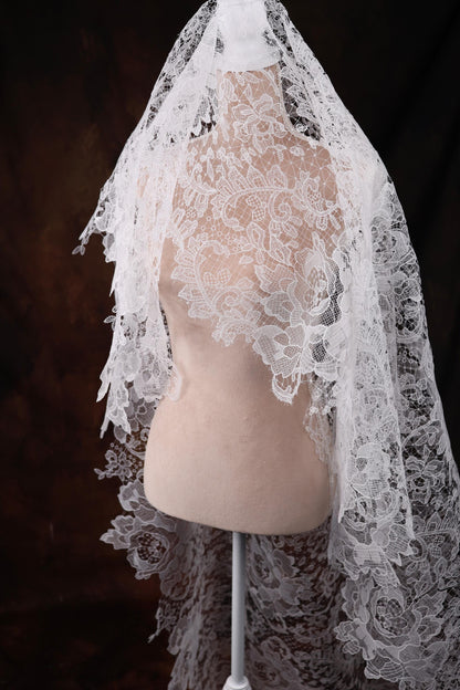 a mannequin with a white veil on top of it