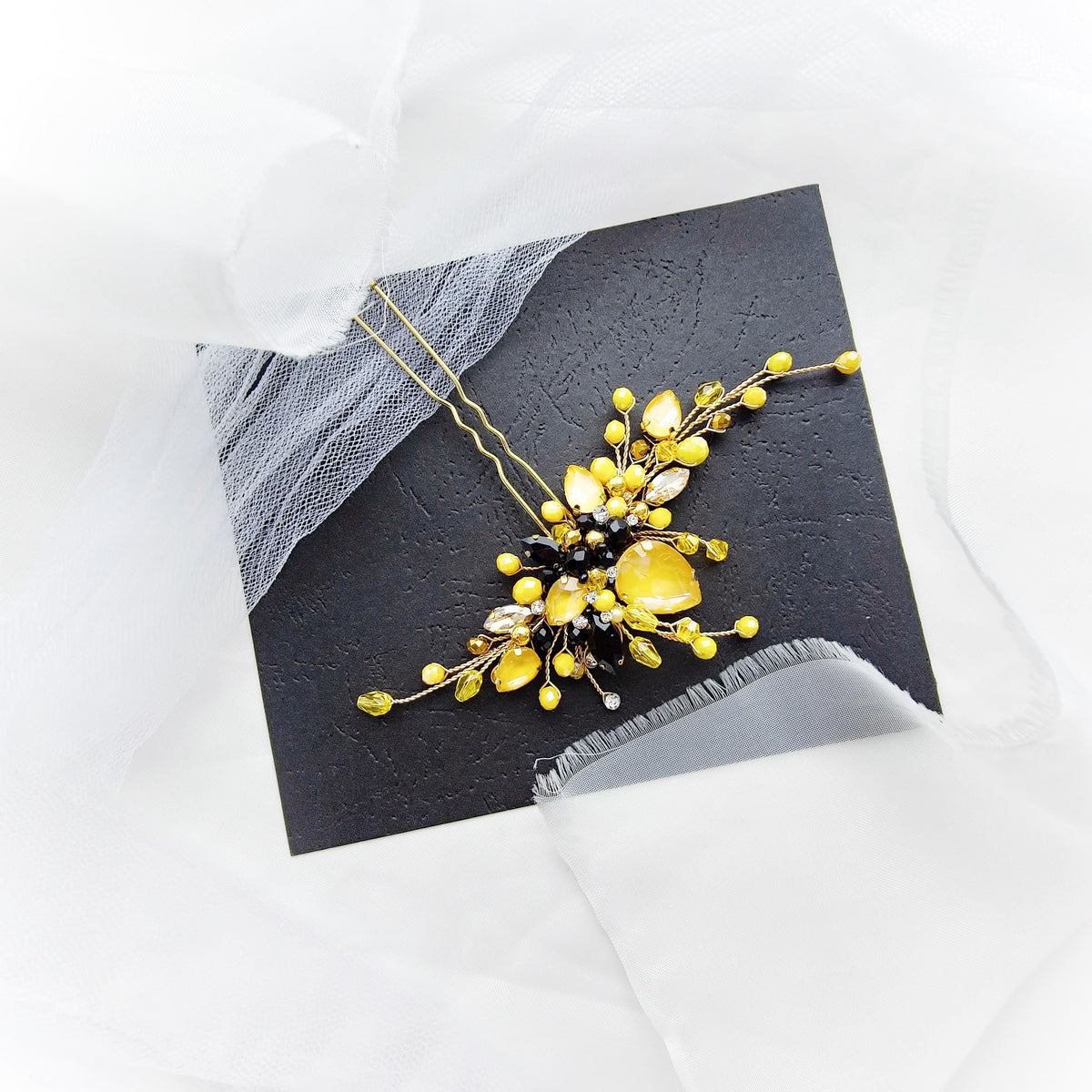 a picture of a yellow flower on a black piece of paper