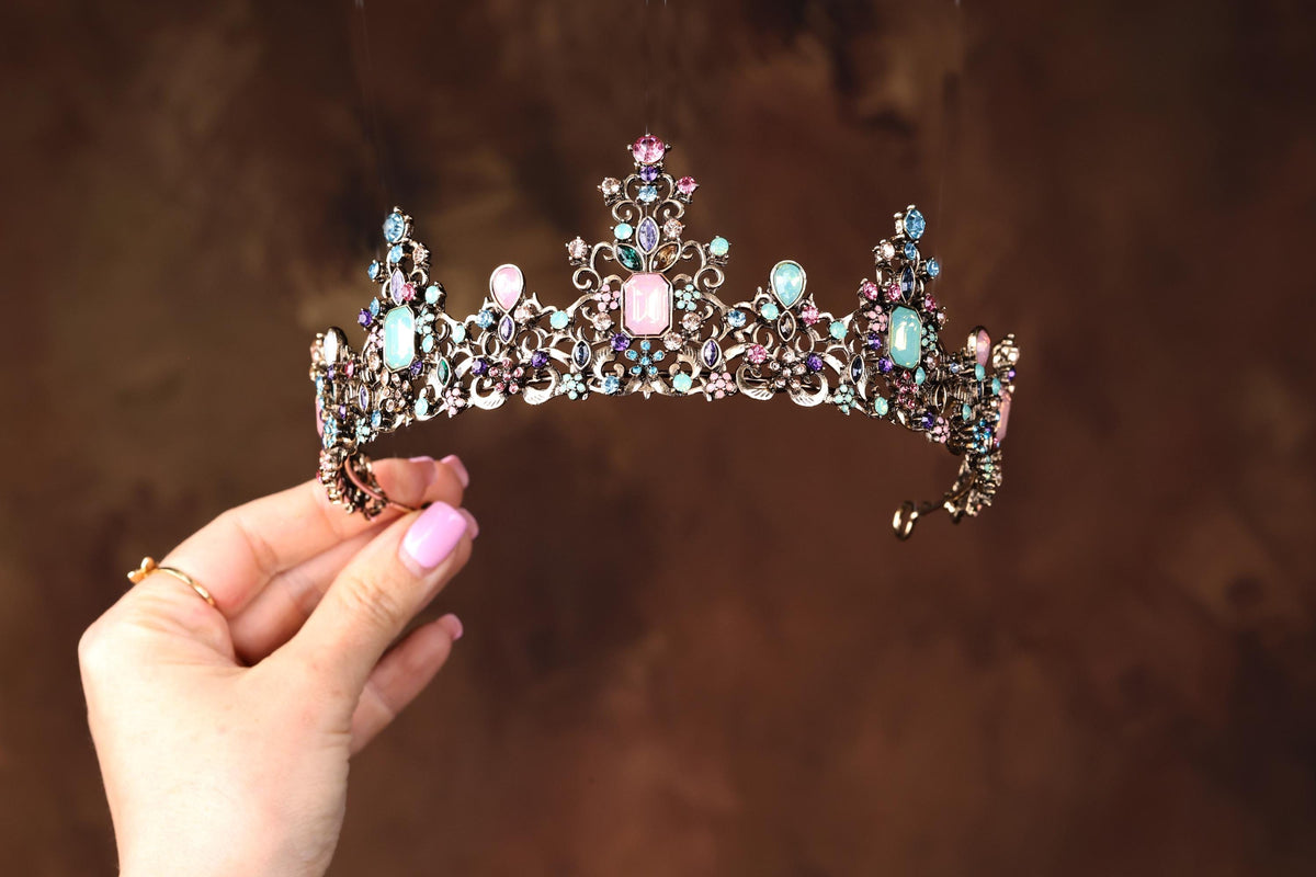 a woman holding a tiara in her hand