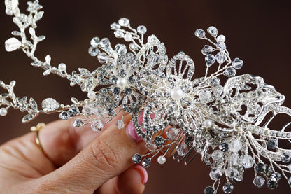 a close up of a person holding a tiara