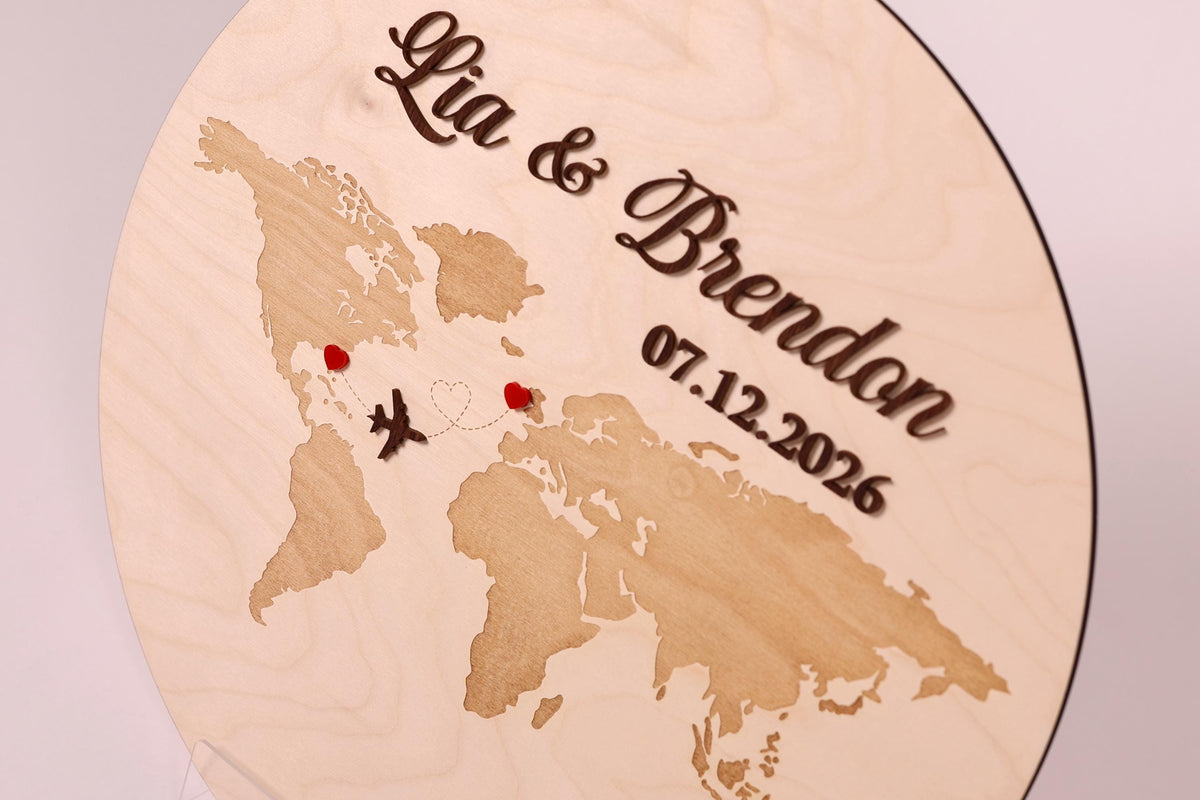 A wooden sign with a world map and the names 'Lia & Brandon' written on it.