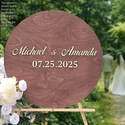 A wooden sign displaying the names "Michael & Amanda" and the date "07.25.2025" is surrounded by white flowers, with a blurred background of a couple walking.