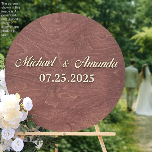A wooden sign displaying the names "Michael & Amanda" and the date "07.25.2025" is surrounded by white flowers, with a blurred background of a couple walking.