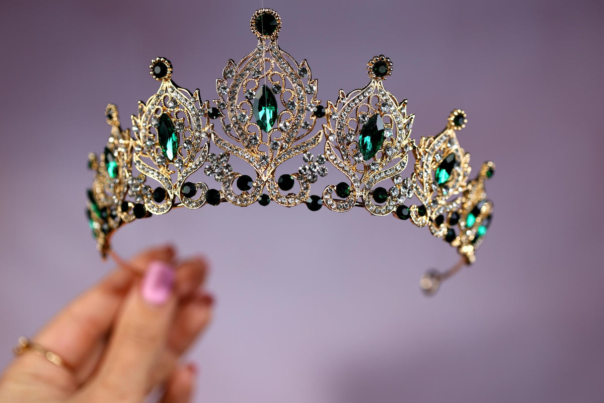 a woman holding a tiara in her hand