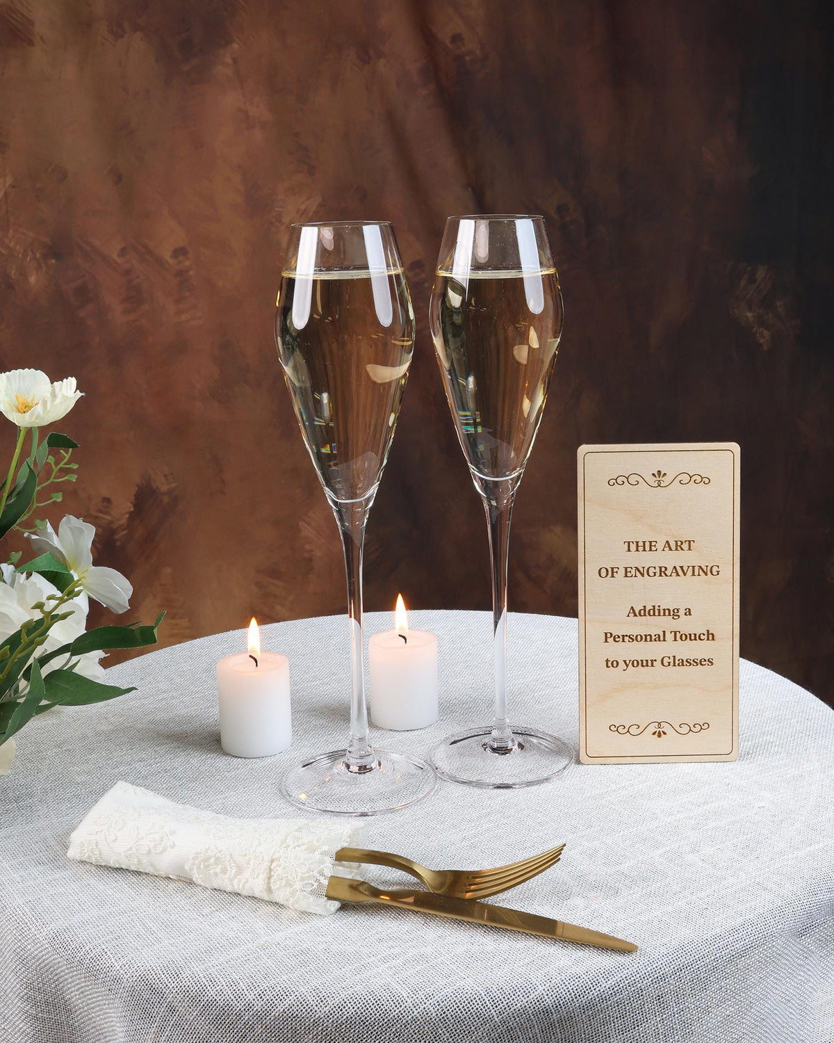 two glasses of champagne sitting on top of a table