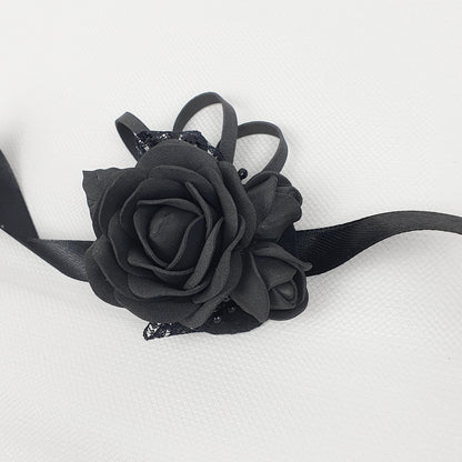 a black rose on a black ribbon on a white background