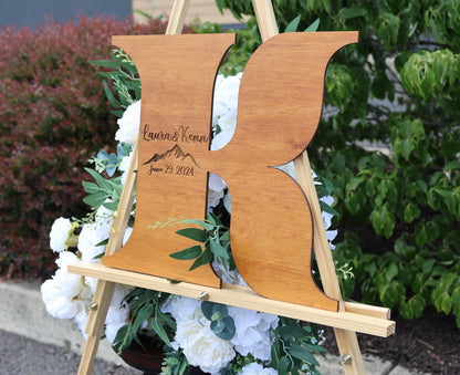 a wooden easel with a couple's initials on it