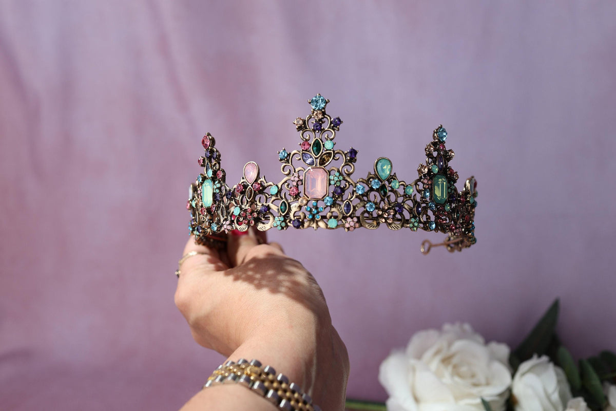 a woman is holding a tiara in her hand