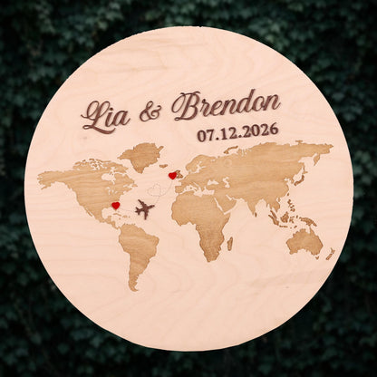 A wooden plaque with a world map and two hearts, representing the relationship between two people.