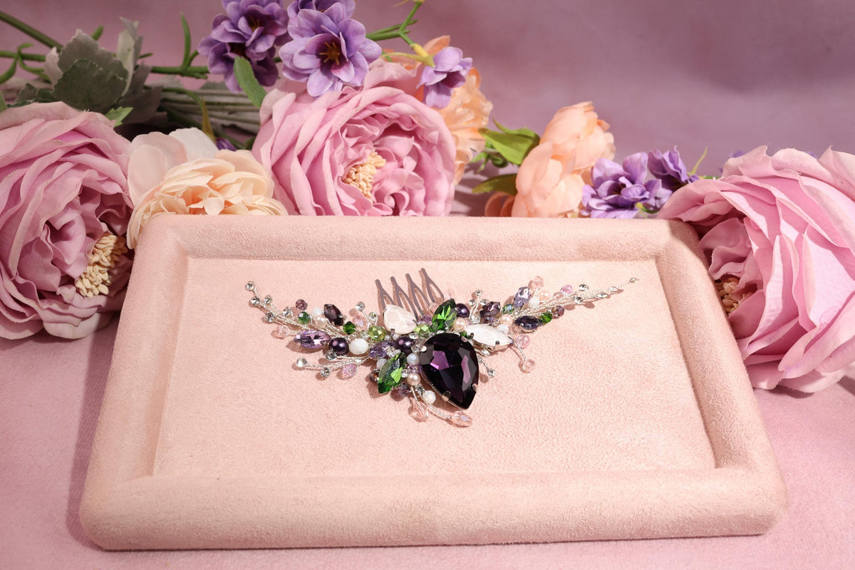 a close up of a brooch with flowers in the background