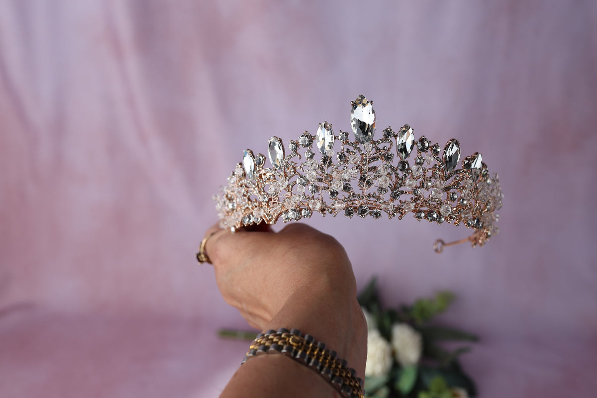 a woman holding a tiara in her hand