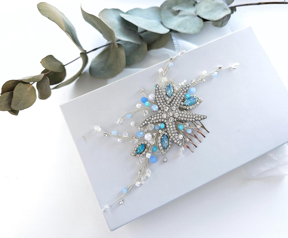 a white box with a blue and white brooch on it