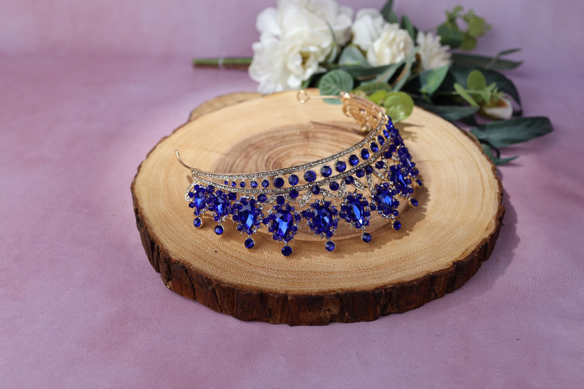a woman's hand holding a blue beaded bracelet