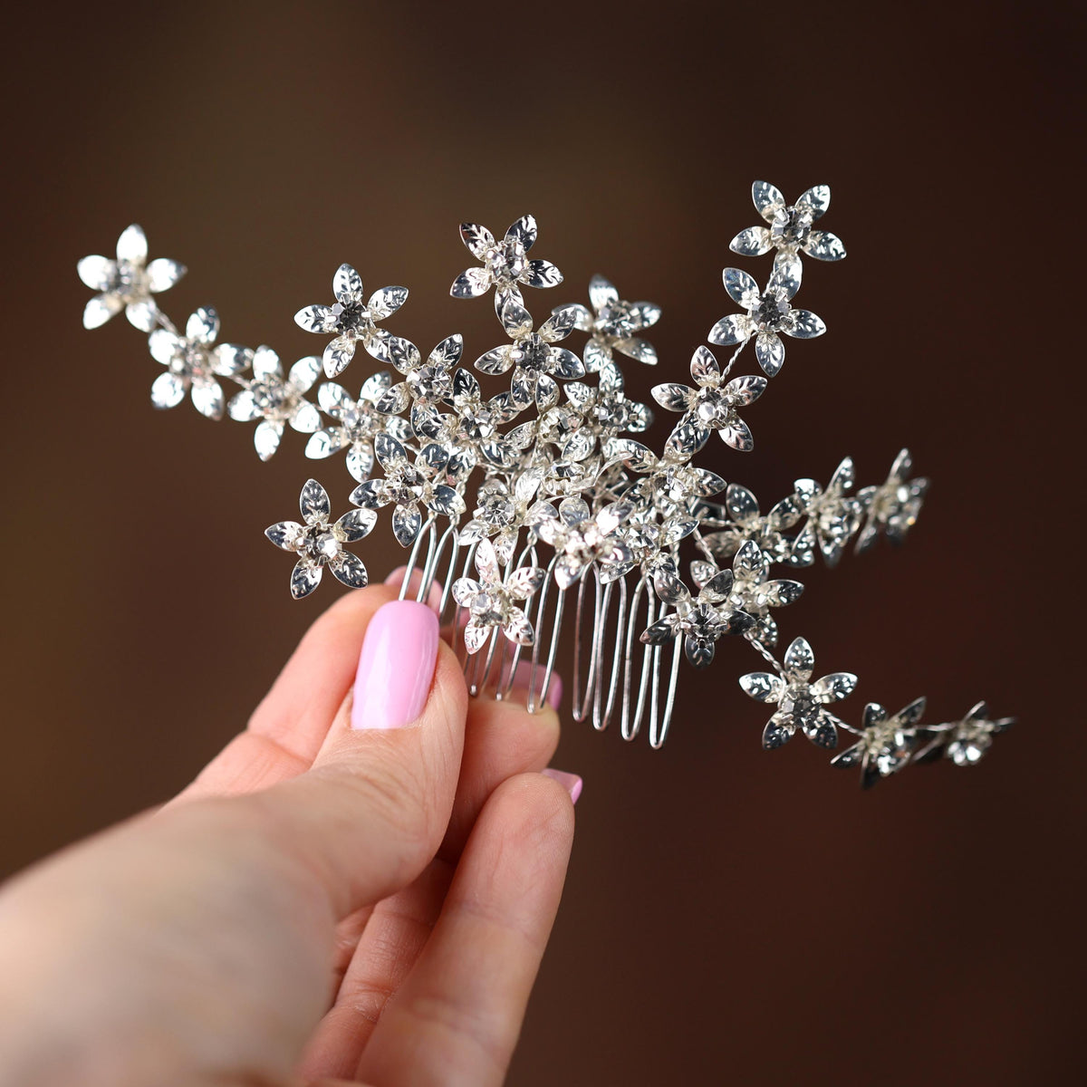a woman holding a hair comb in her hand