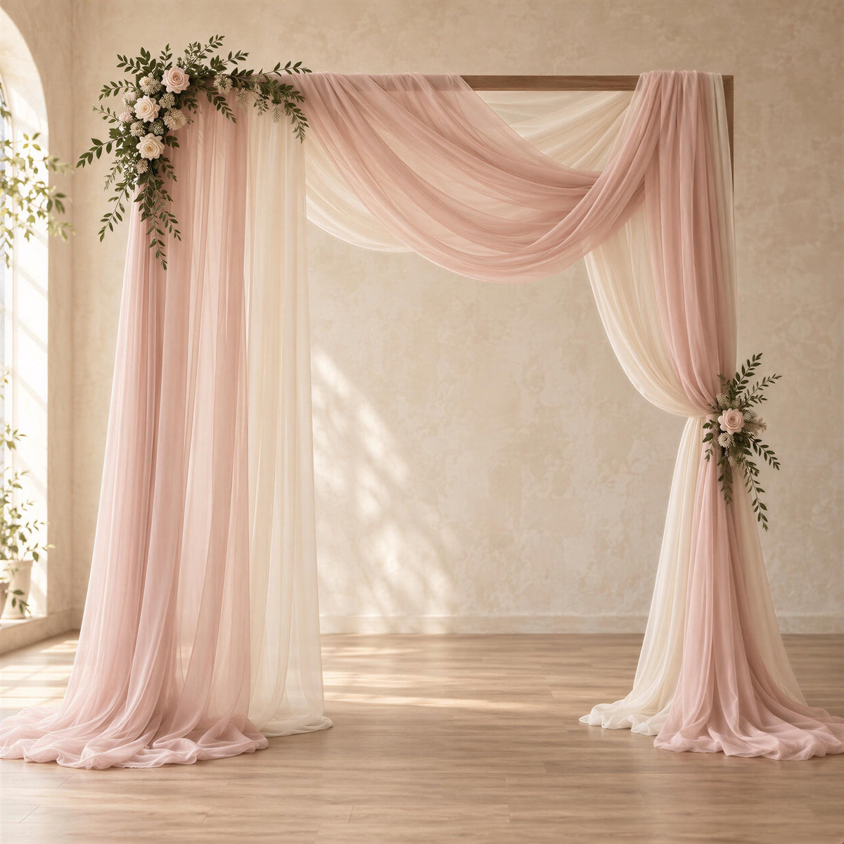 a beautifully decorated wedding arch with pink and white curtains, adorned with flowers and greenery. The arch is set against a backdrop of a white wall, creating a serene and elegant atmosphere for a wedding ceremony.