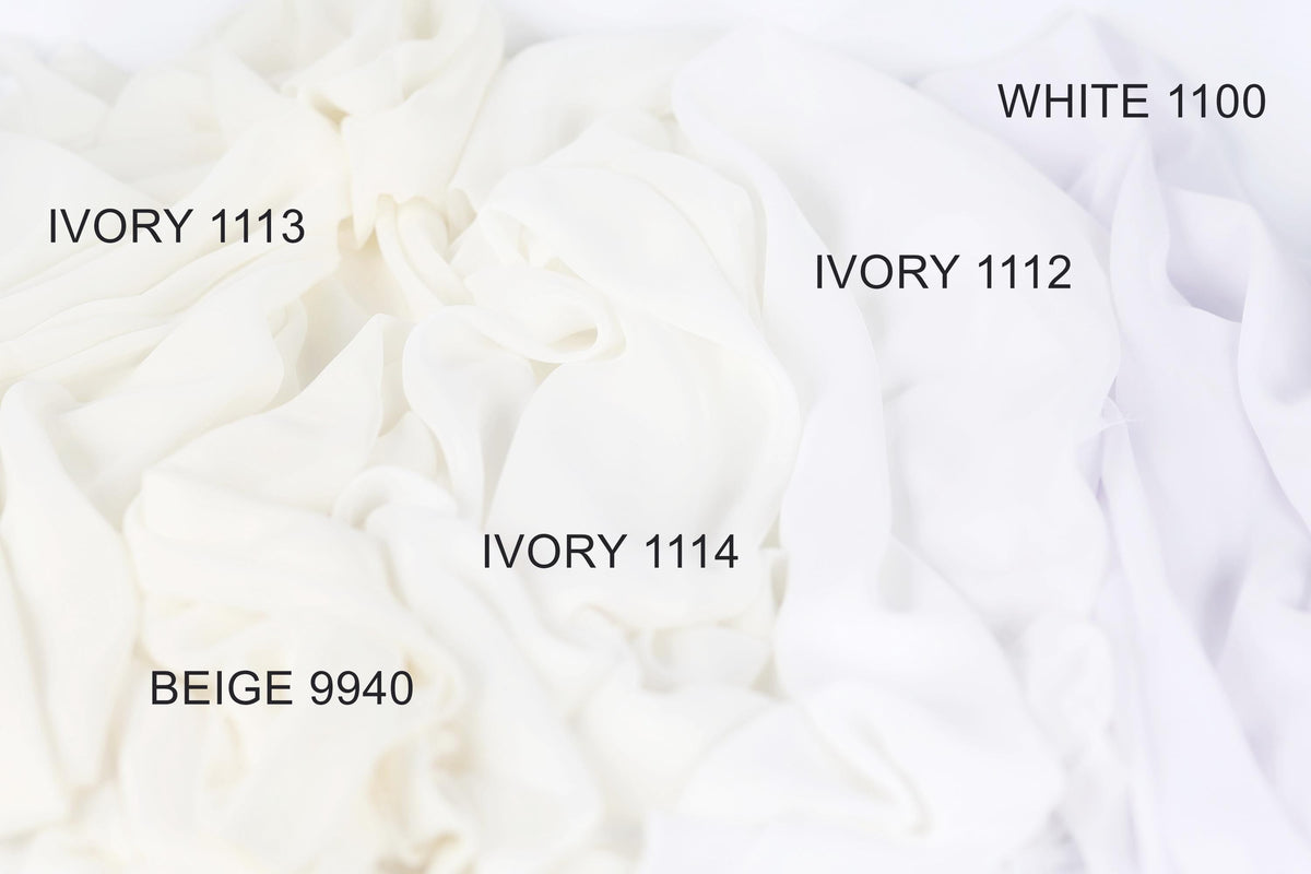 a close-up view of white fabric swatches, each with a different shade of white ranging from Ivory 1113 to White 1100. The swatches are arranged in a grid-like pattern, with each shade labeled with its corresponding name.