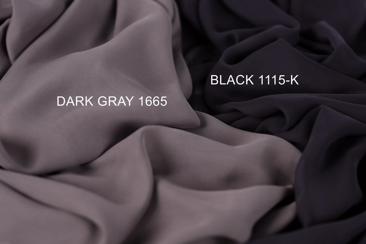 two different fabric swatches, one dark gray and one black, with the dark gray fabric labeled as "Dark Gray 1665" and the black fabric labeled as "Black 1115-K".