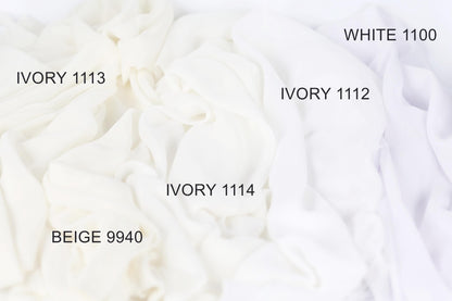a close-up view of white fabric swatches, each with a different shade of white ranging from Ivory 1113 to White 1100. The swatches are arranged in a grid-like pattern, with each shade labeled with its corresponding name.