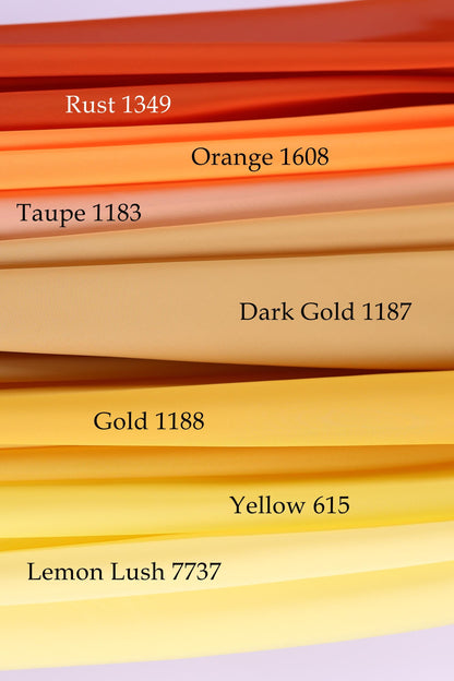 a collection of fabric swatches in various colors, including rust, orange, taupe, dark gold, yellow, and lemon.