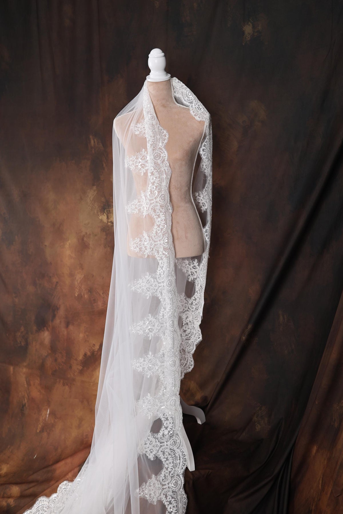 a mannequin with a white veil on top of it