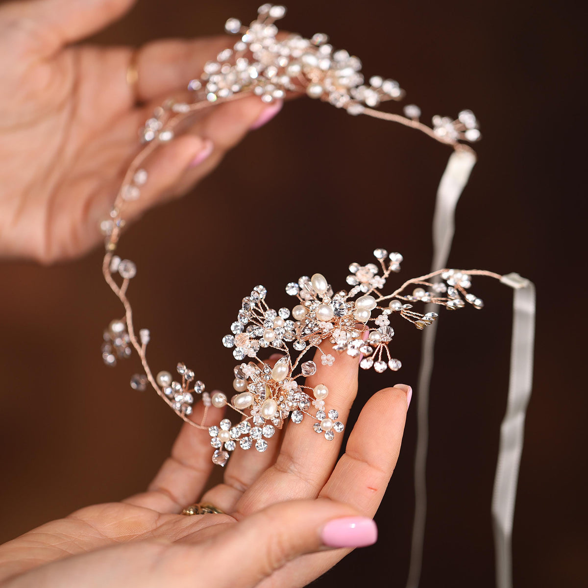 a close up of a person holding a tiara