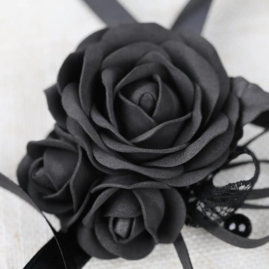 A close-up image of a black rose flower with a lace bow.