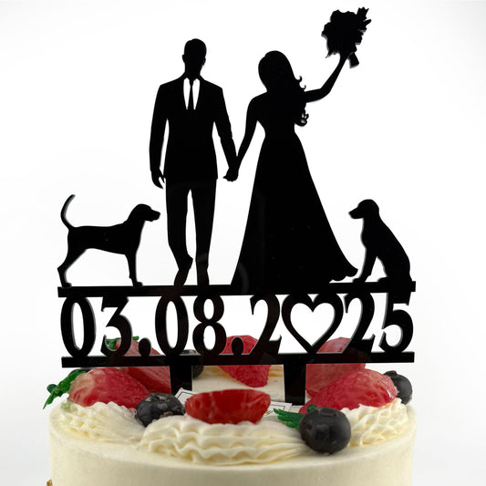 a cake with a silhouette of a bride and groom and a dog