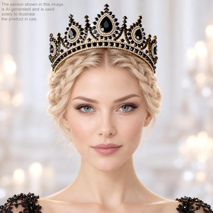 A woman with blonde hair wearing a black and gold crown with a diamond-encrusted design, posing for a portrait against a blurred background.
