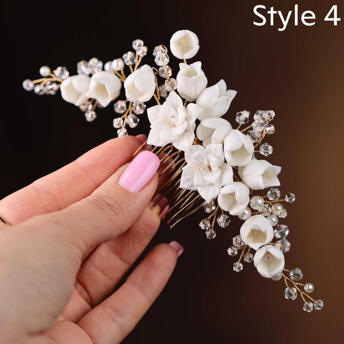 a woman's hand holding a comb with flowers on it