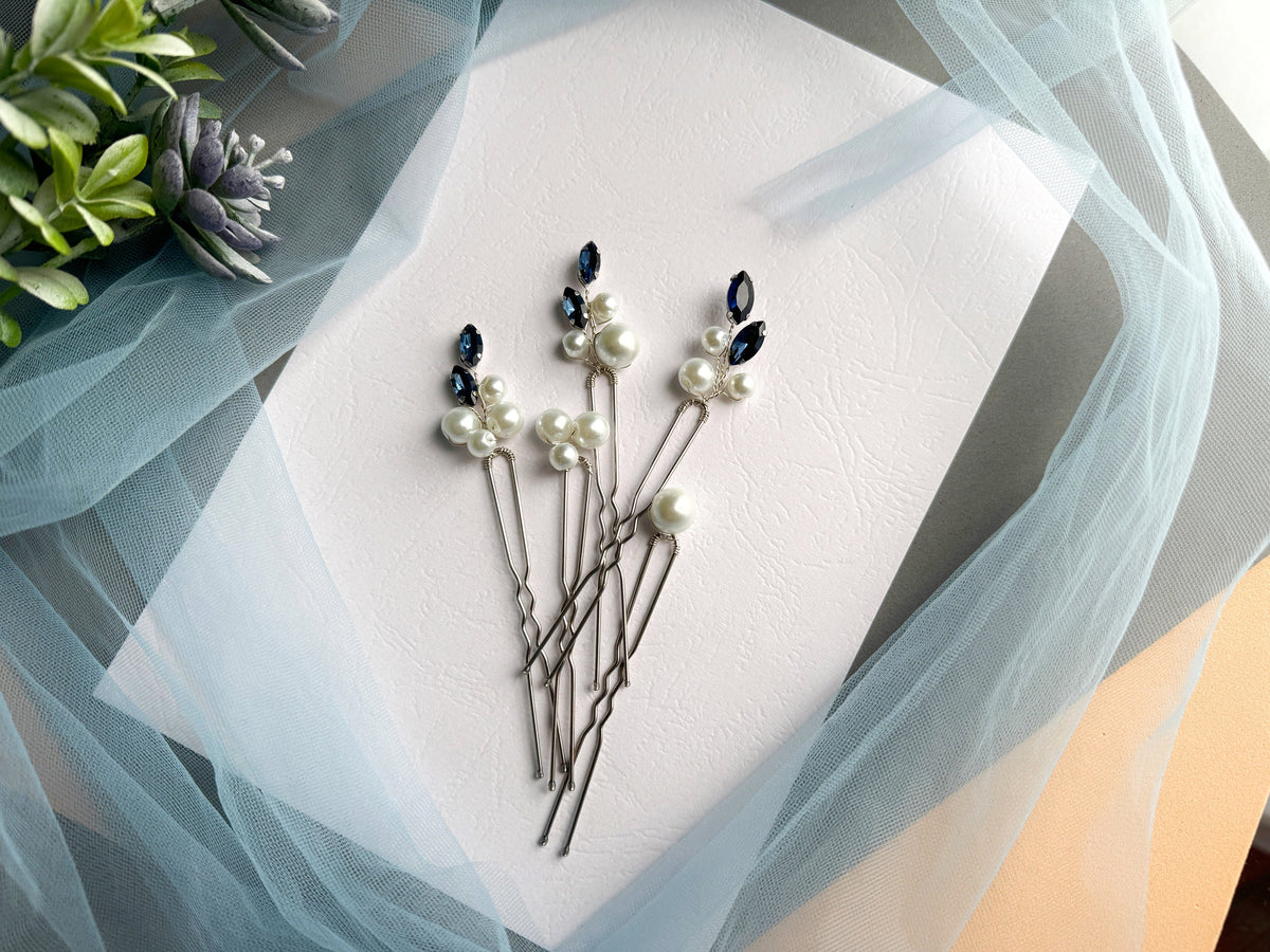 a bunch of pins sitting on top of a piece of paper