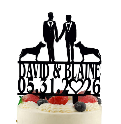 A black silhouette of two men in suits standing on top of a cake with a heart and the date "05.31.26" written on it.
