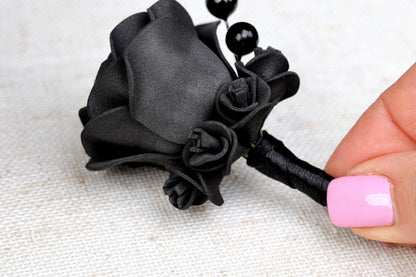 a woman's hand with a pink and black manicure