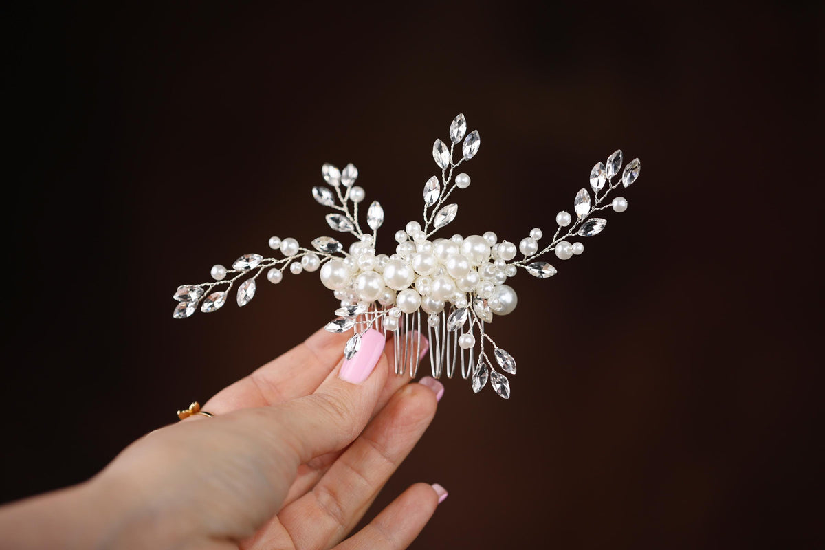 a person holding a hair comb in their hand