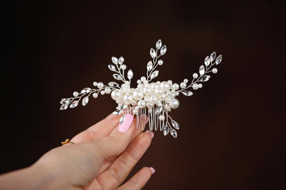 a person holding a hair comb in their hand