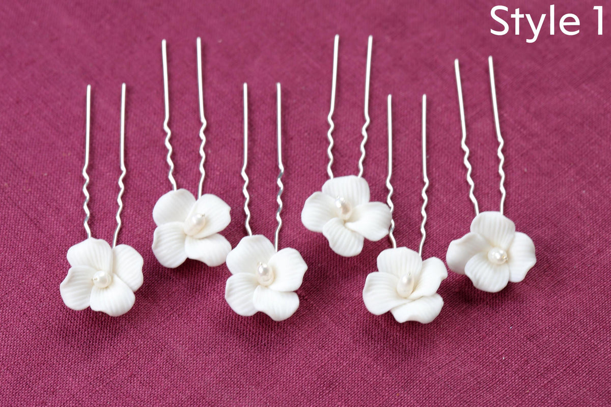 a group of four white flowers sitting on top of a table