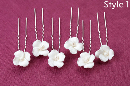a group of four white flowers sitting on top of a table