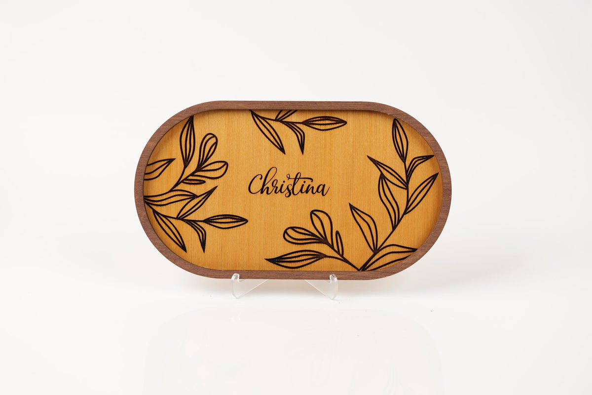 a wooden tray with a floral design and the name "Christina" written on it.