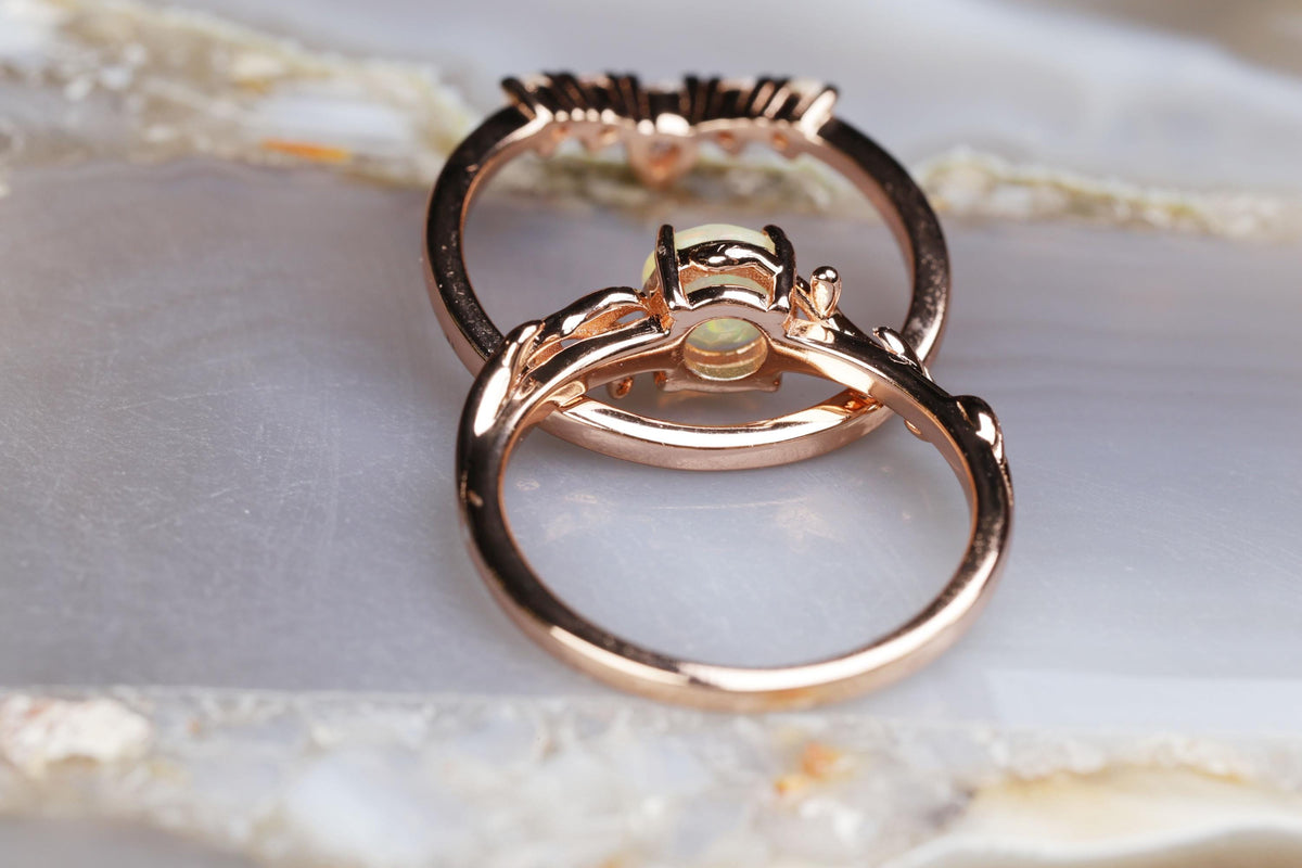a couple of gold rings sitting on top of a table