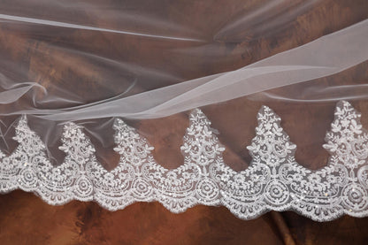 a close up of a white lace on a fabric