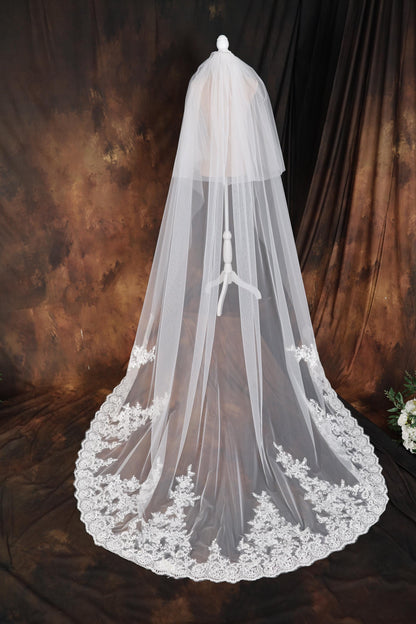 a wedding veil with white flowers on it