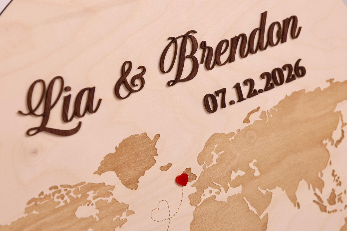a wooden map with the names 'Lia & Brandon' and the date '07.12.2026' written on it.