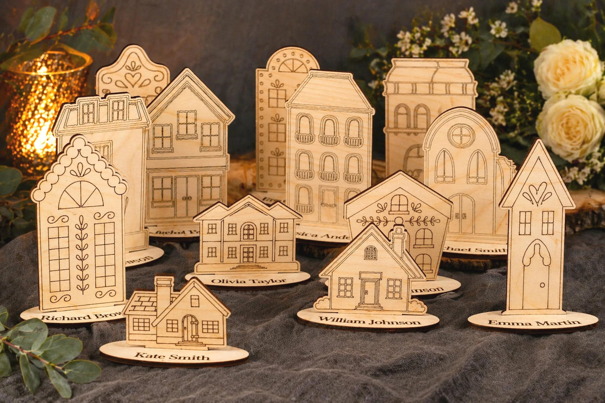 A collection of wooden houses or buildings, each with unique designs and decorations, arranged on a dark surface. The houses appear to be made of wood and are placed on small platforms or stands.